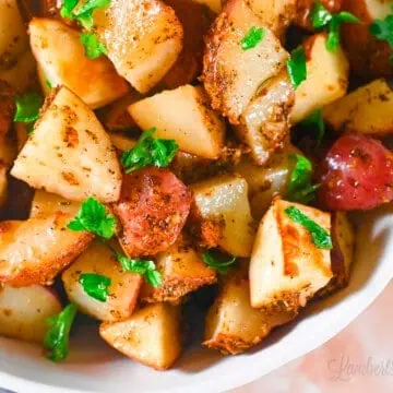 air fryer red potatoes in a bowl, with a garnish of parsley.