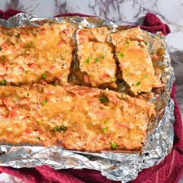 loaves of crawfish bread on aluminum foil.