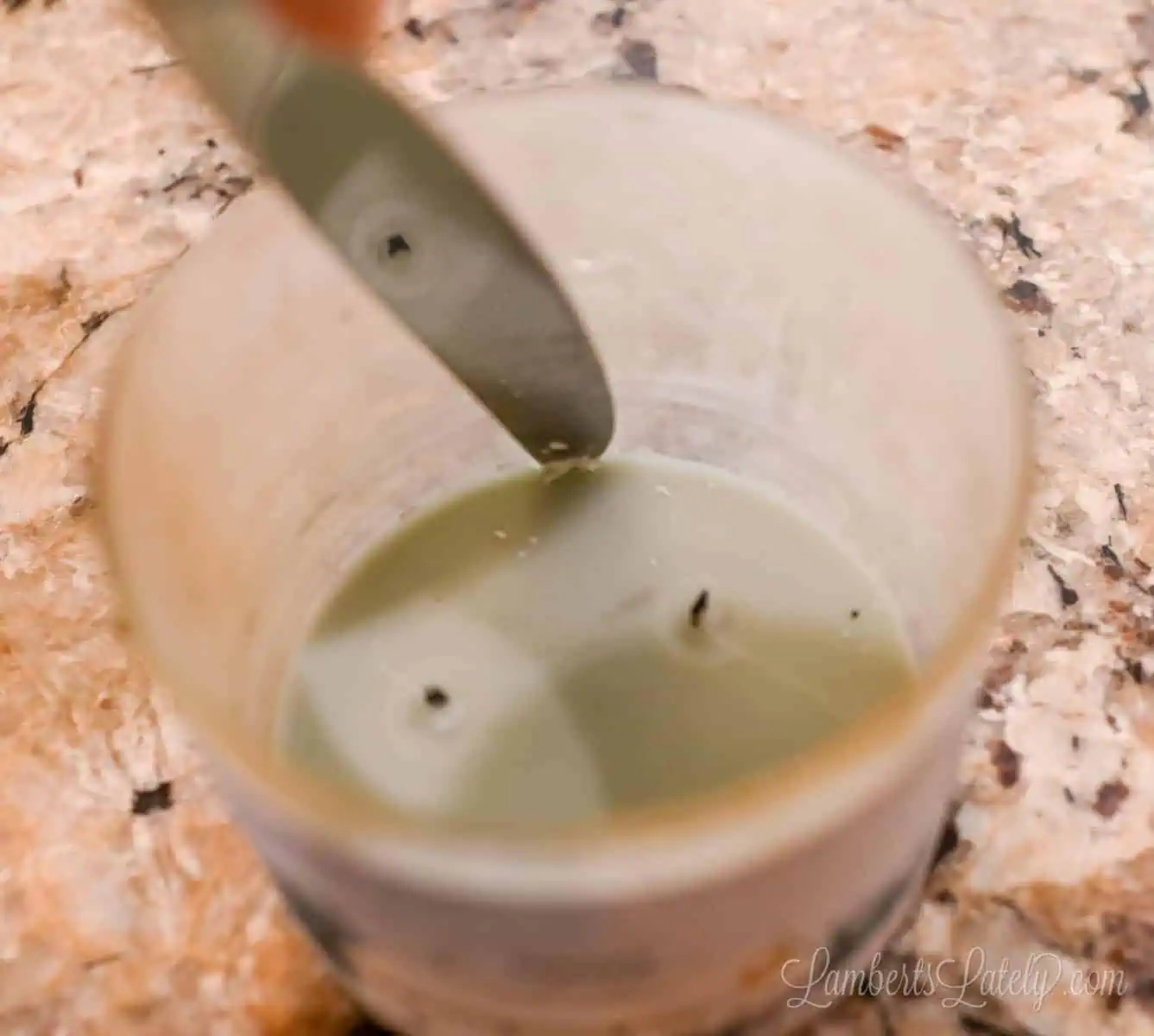 using a butter knife around the edge of the wax in a jar.