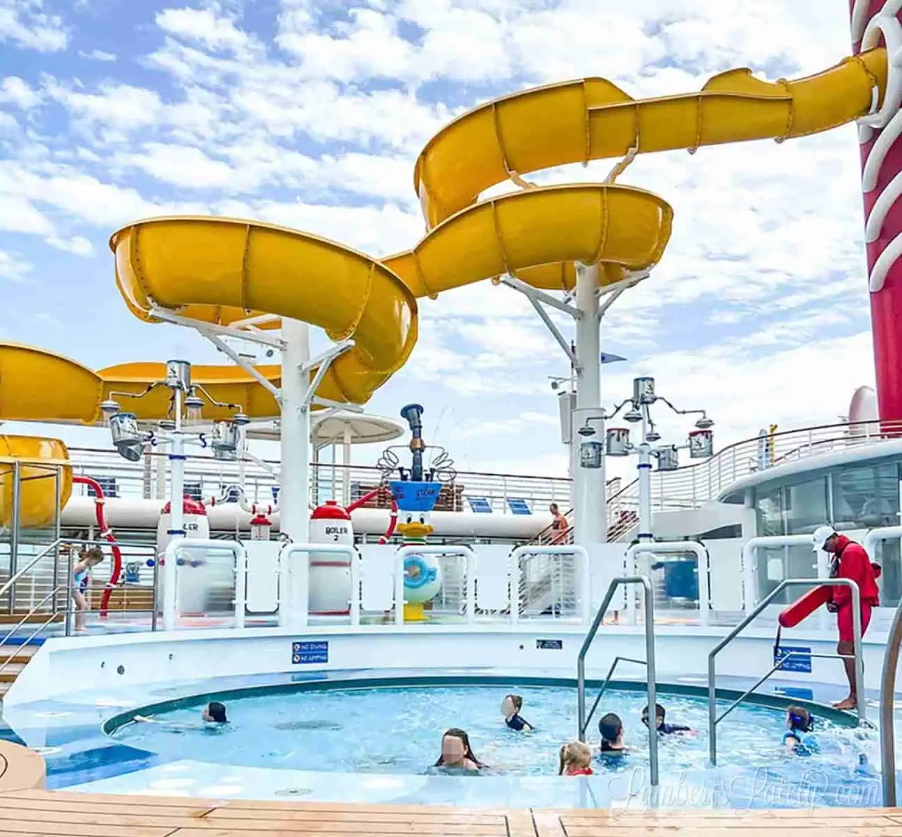children in a pool and a lifeguard on the deck of the disney wonder cruise ship.