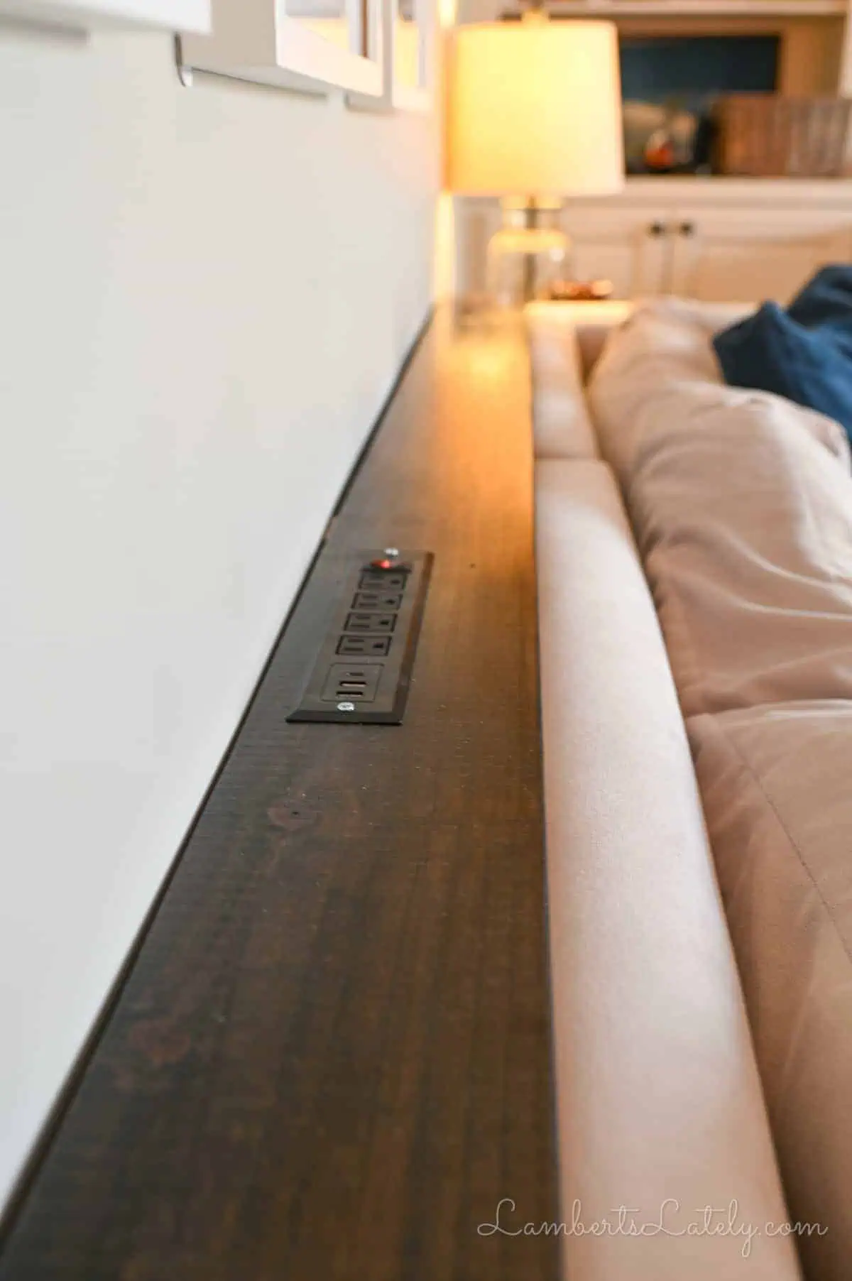 behind the couch table with outlet.