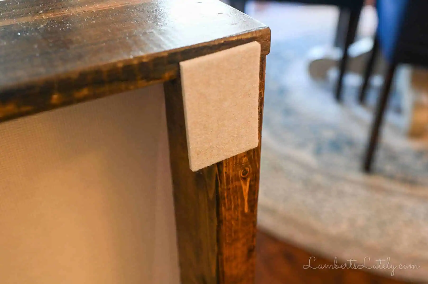 felt pad on the back of a behind the couch table.