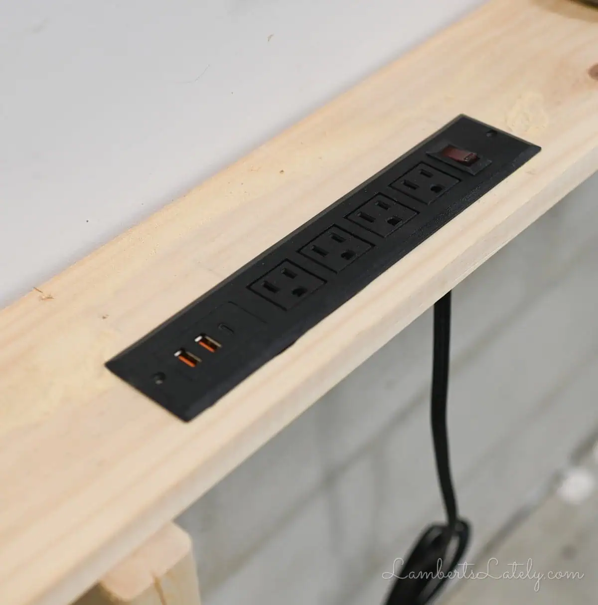 power strip in hole in the table.