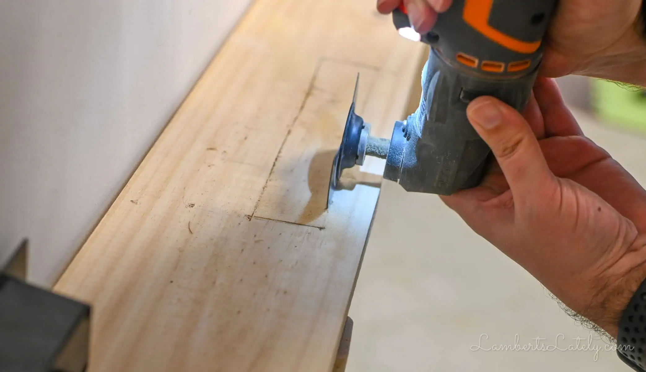 using an oscillating tool to cut a hole in wood.