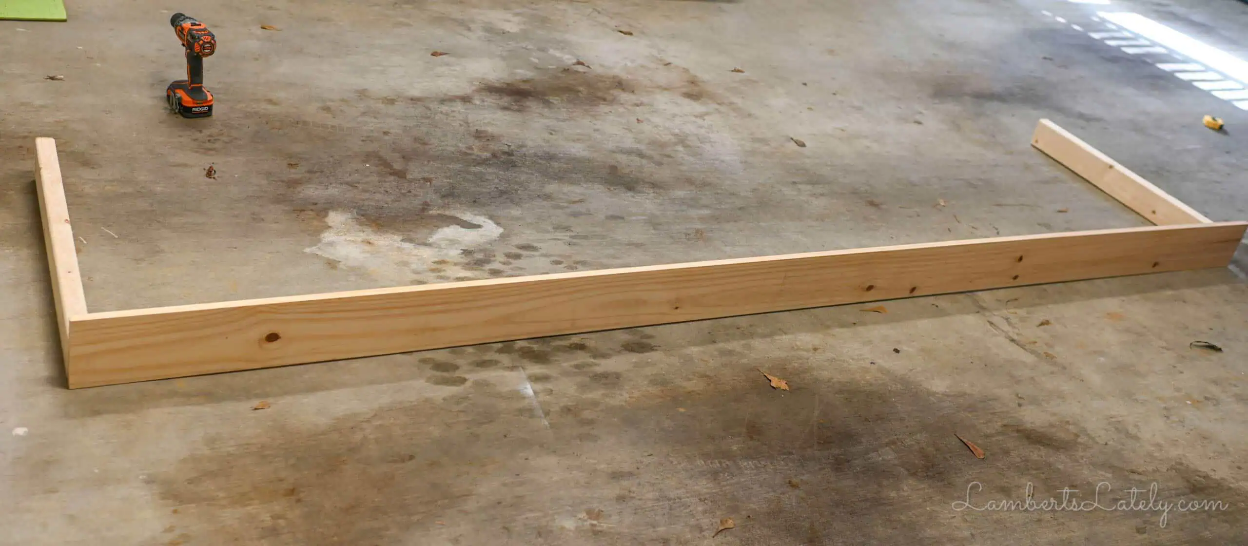 table with two legs on a garage floor.