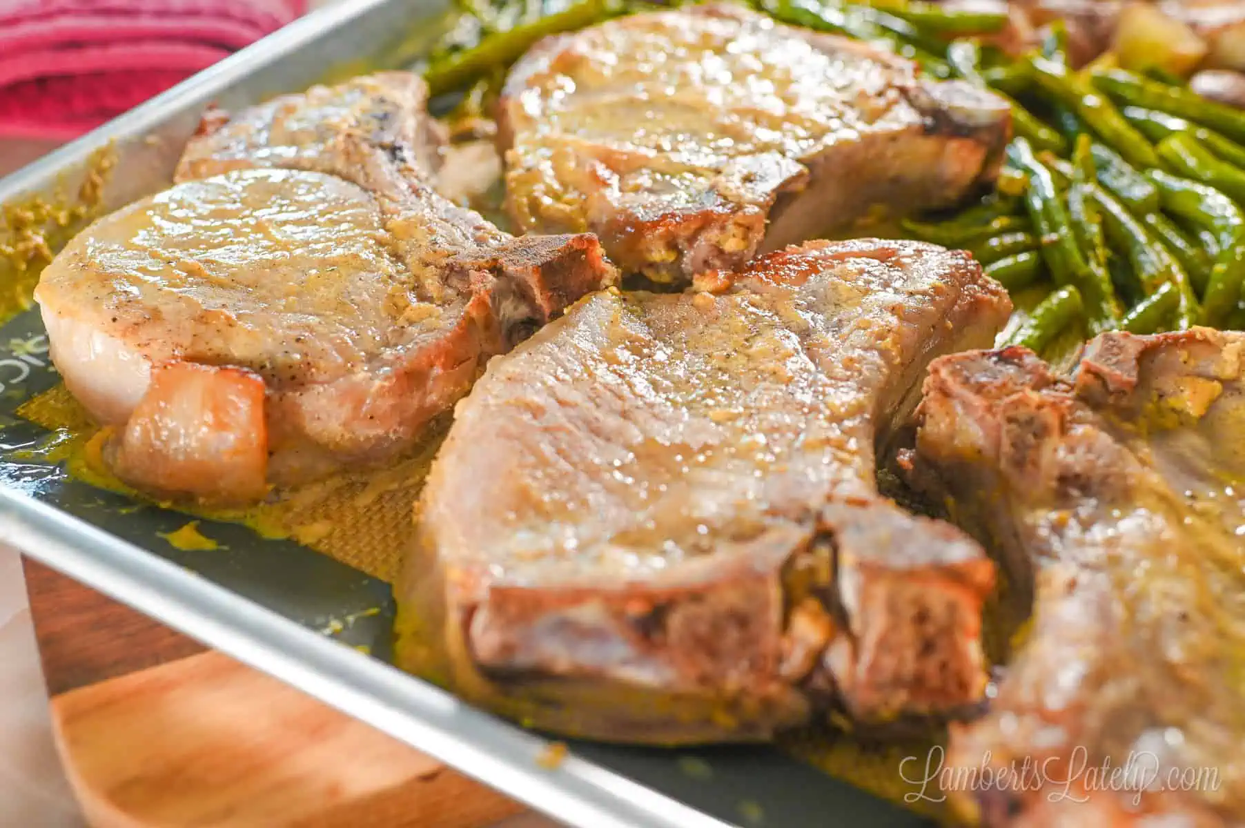 cooked pork chops on a sheet pan.