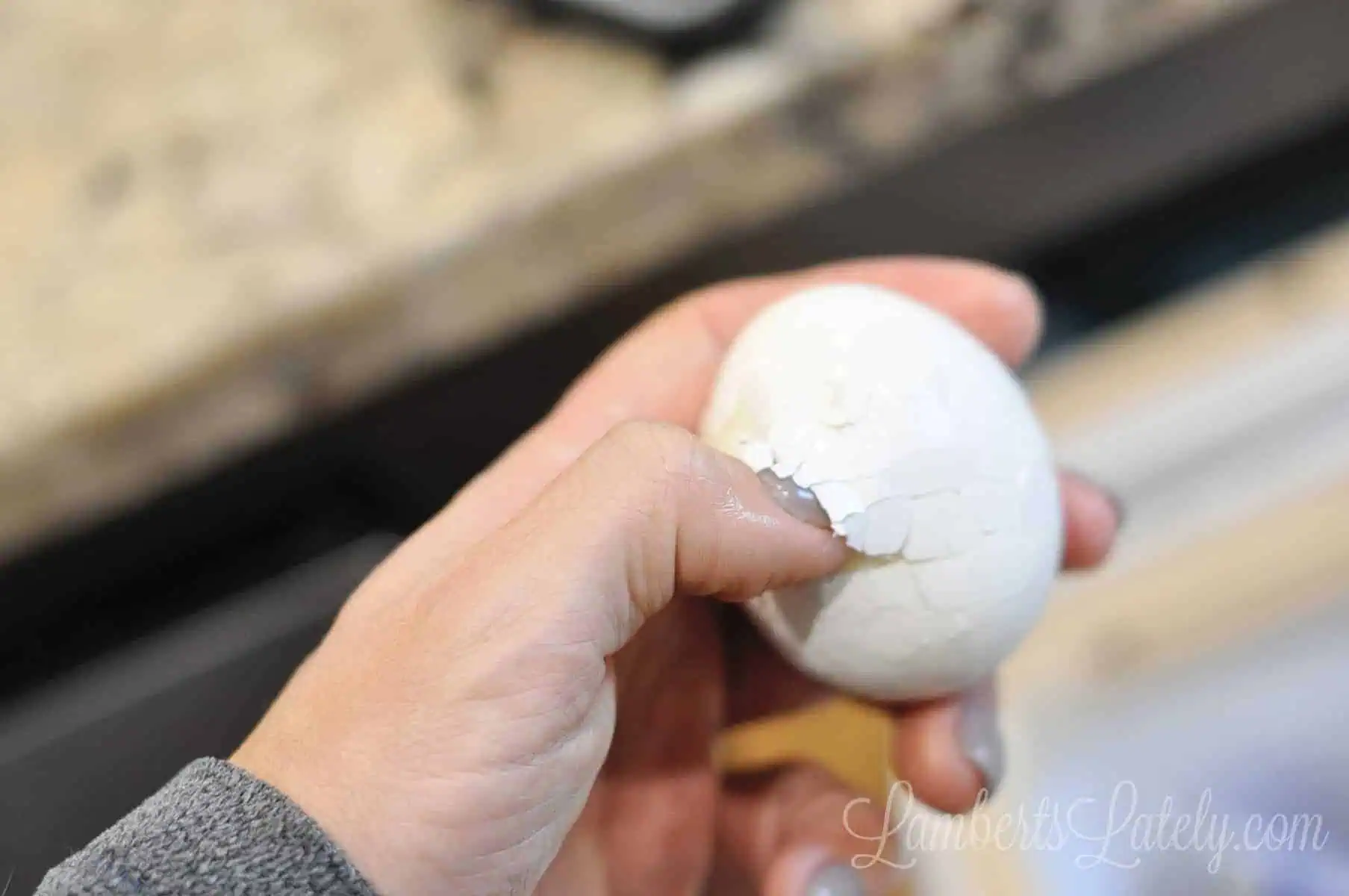 putting your finger under the shell in an egg.