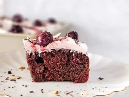 black forest poke cake slice on a plate.