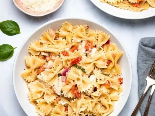 bruschetta chicken pasta on a plate with forks.