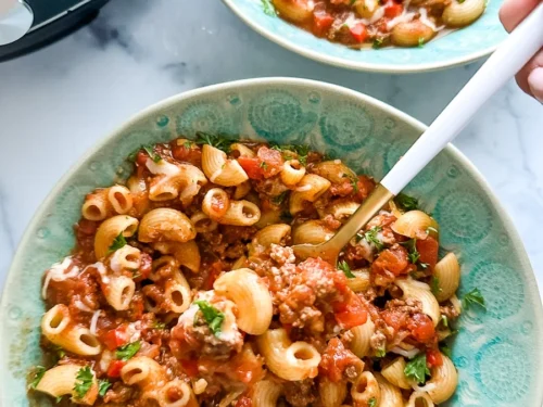 chili mac in a bowl with a spoon.