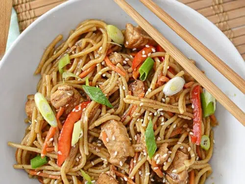 lo mein on a plate with chopsticks.