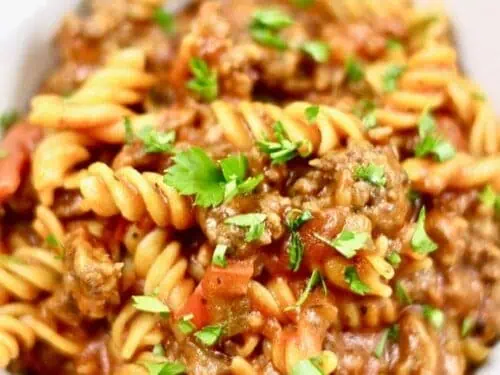 sausage pasta in a tomato sauce in a bowl.