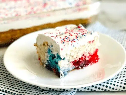 red, white, and blue poke cake on a plate.