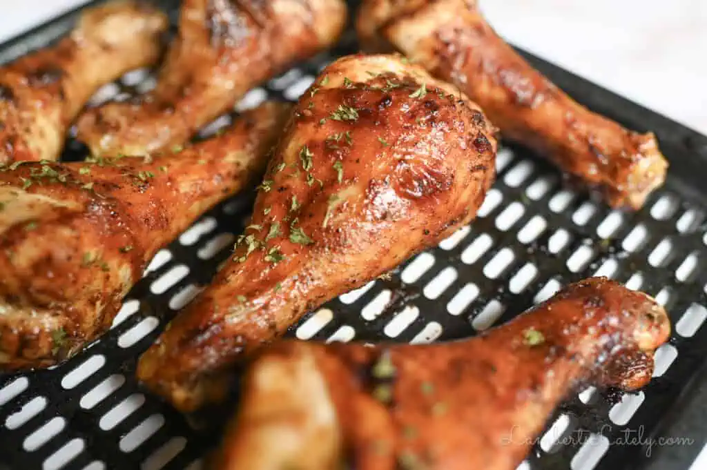 piece of barbecue chicken on an air fryer pan.