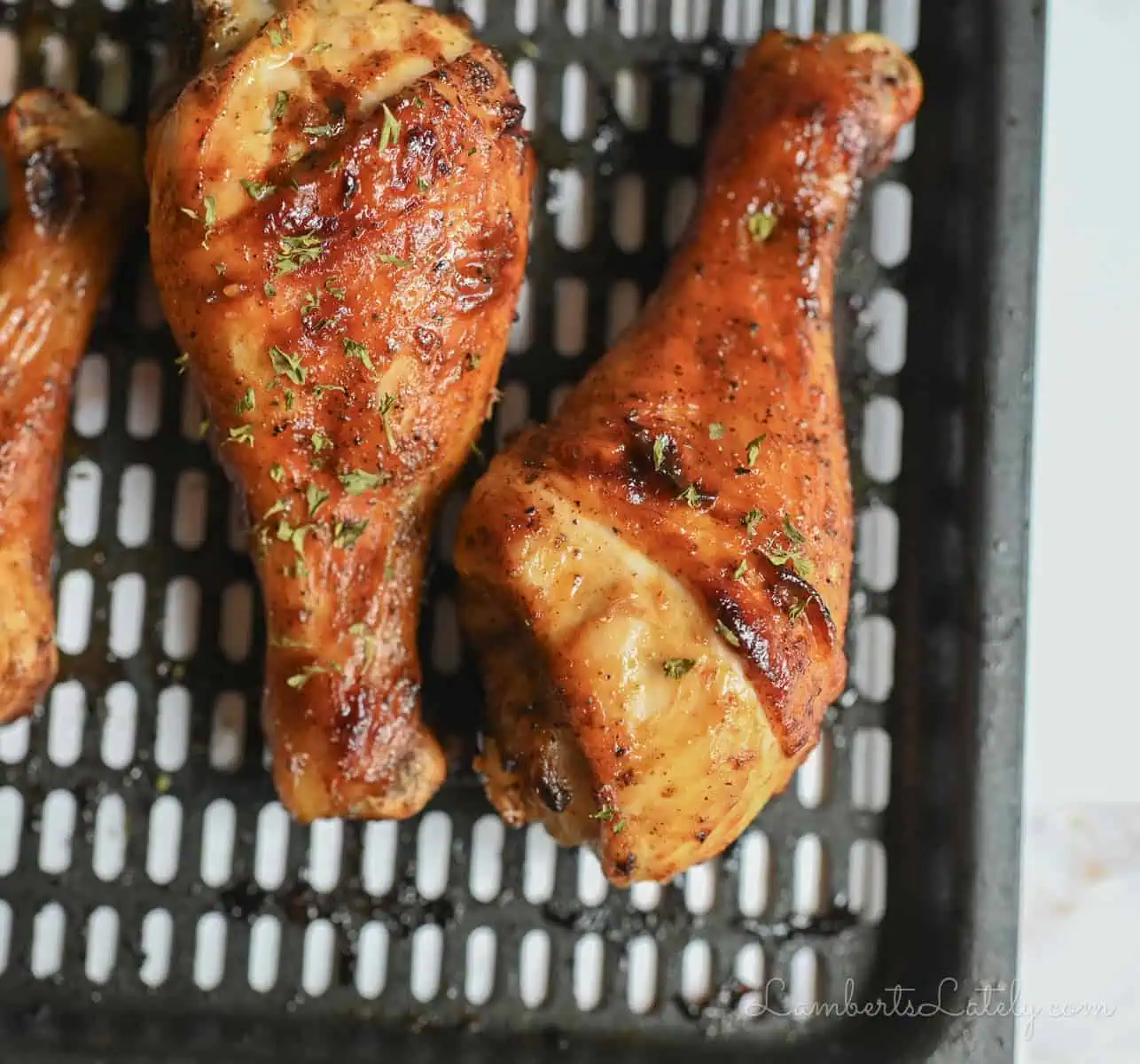 two chicken legs on a pan.