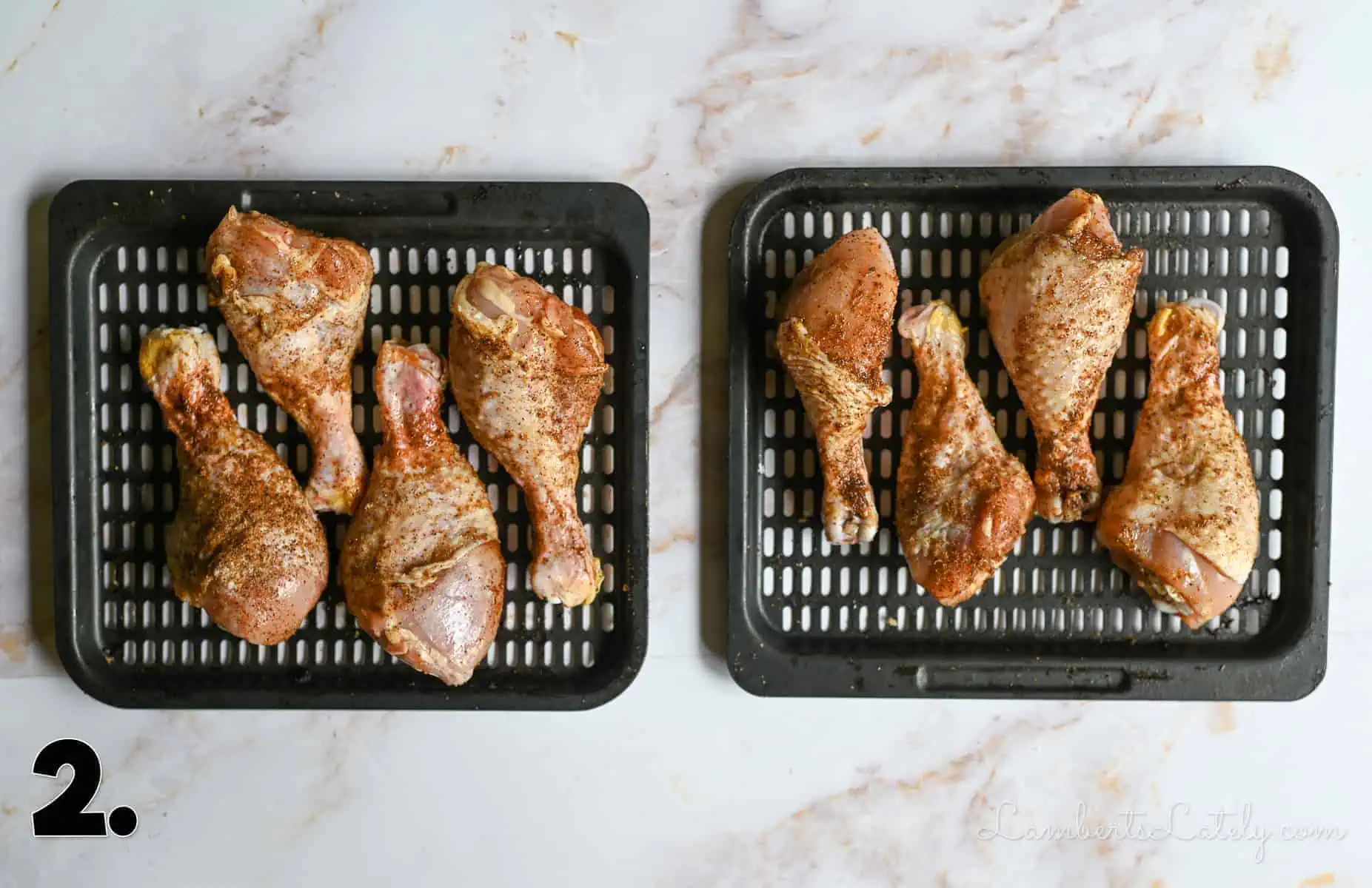 seasoned chicken legs on a pan.