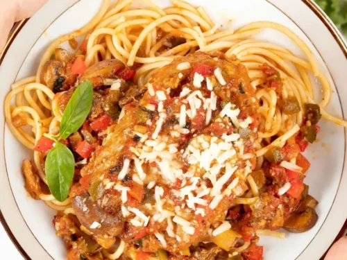 chicken cacciatore on a plate with pasta.