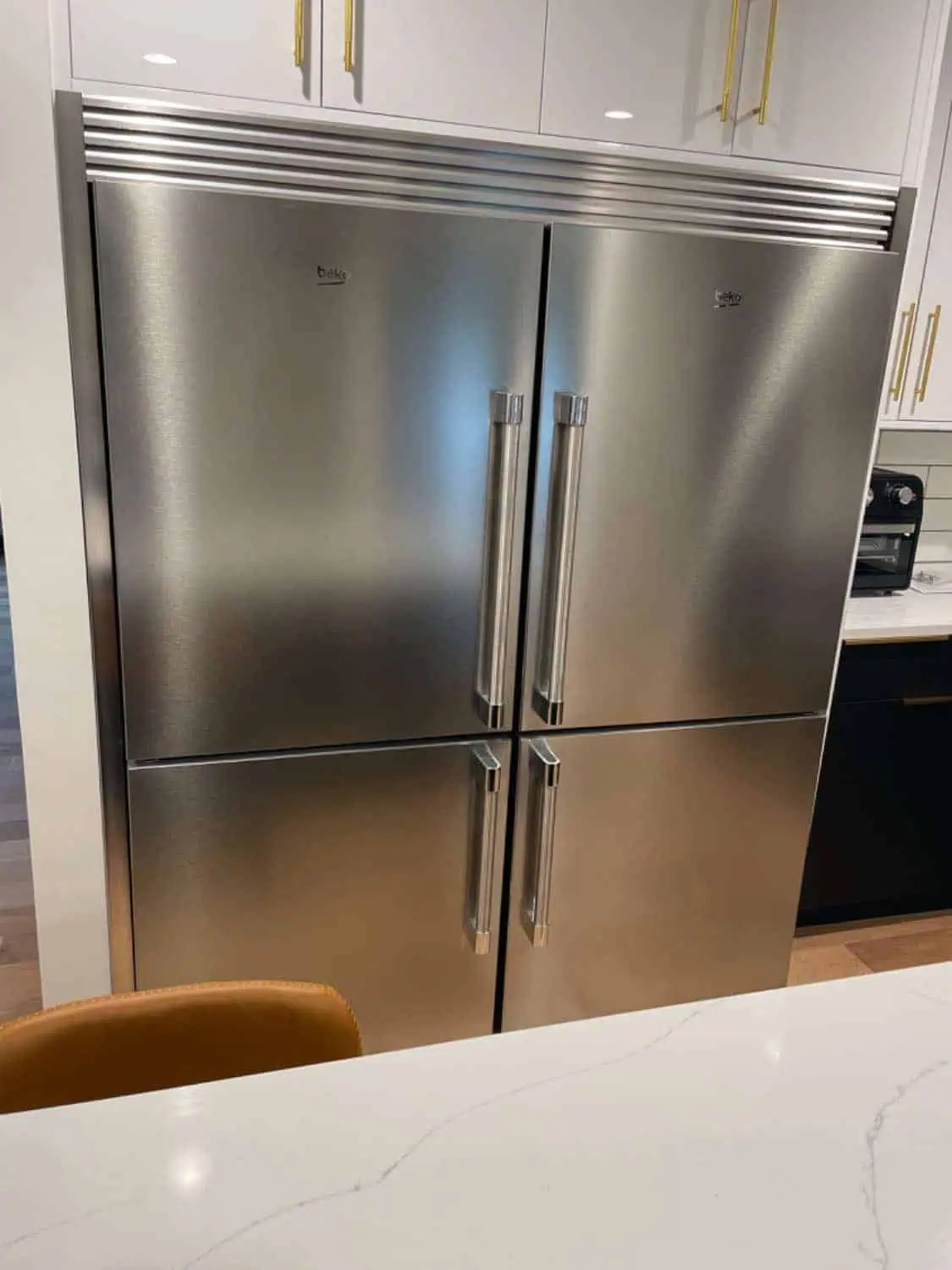 large stainless steel refrigerator with trim kit.