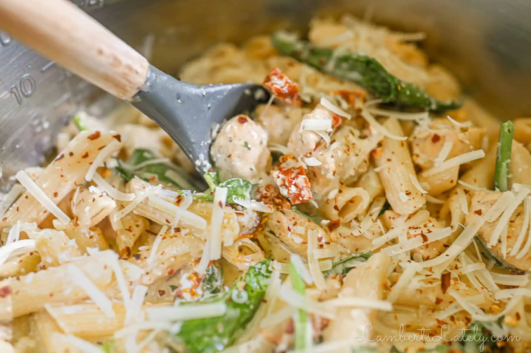 scooping a spoon of marry me chicken pasta.