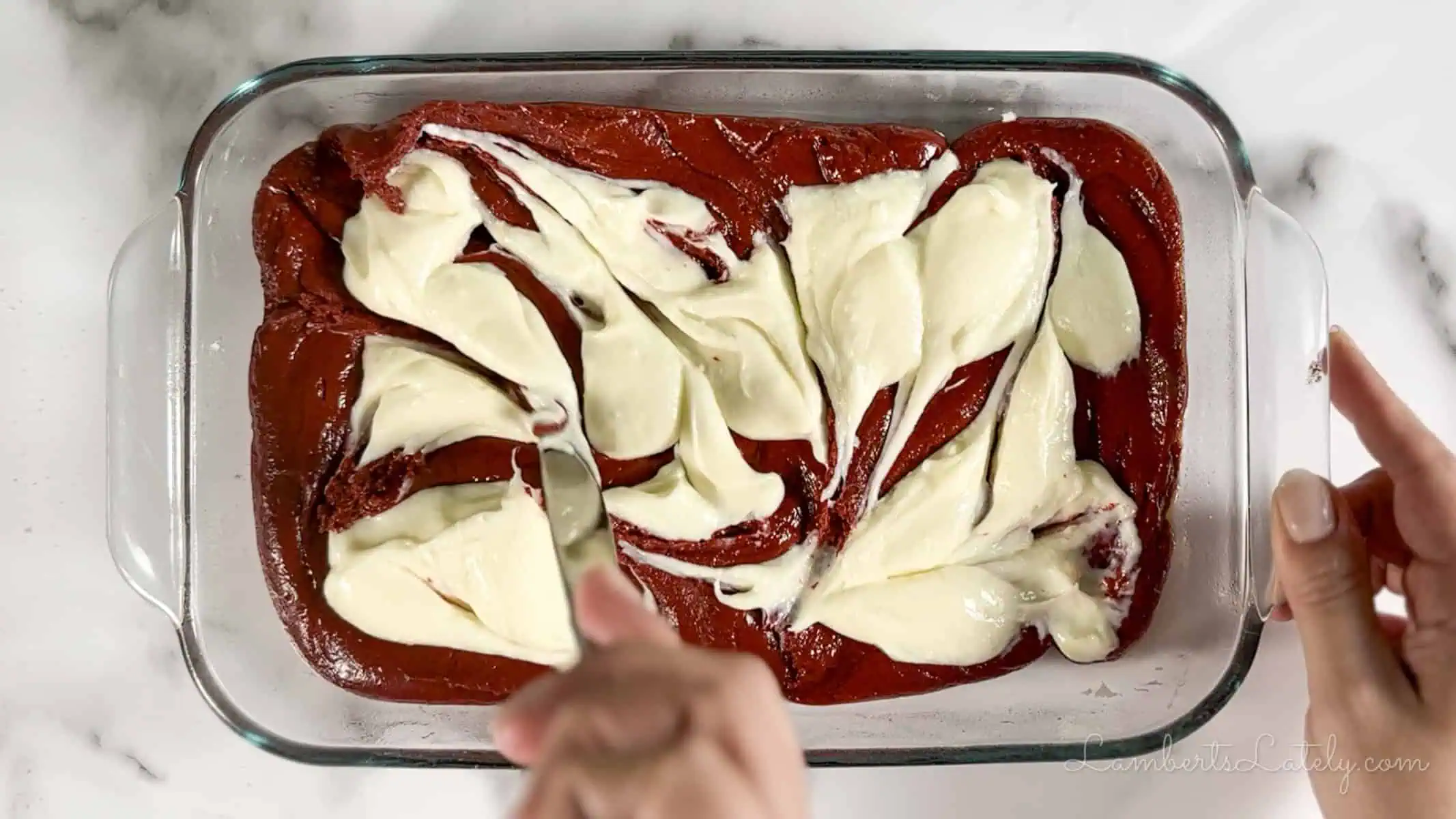 swirling cream cheese mixture into the red velvet brownie batter.
