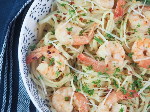 shrimp scampi in a bowl with pasta.