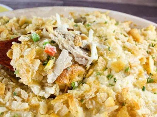 scooping a spoonful of chicken and hashbrown casserole.