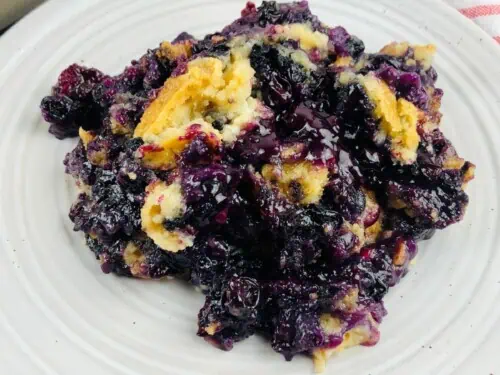 Blueberry dump cake on a plate.