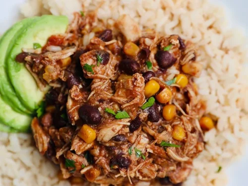 Instant Pot Fiesta Chicken over rice, with avocado.