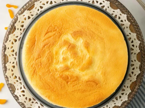 a whole japanese cotton cheesecake next to a serving utensil.