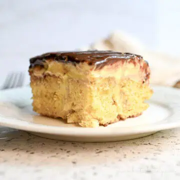 piece of boston creme poke cake on a plate.