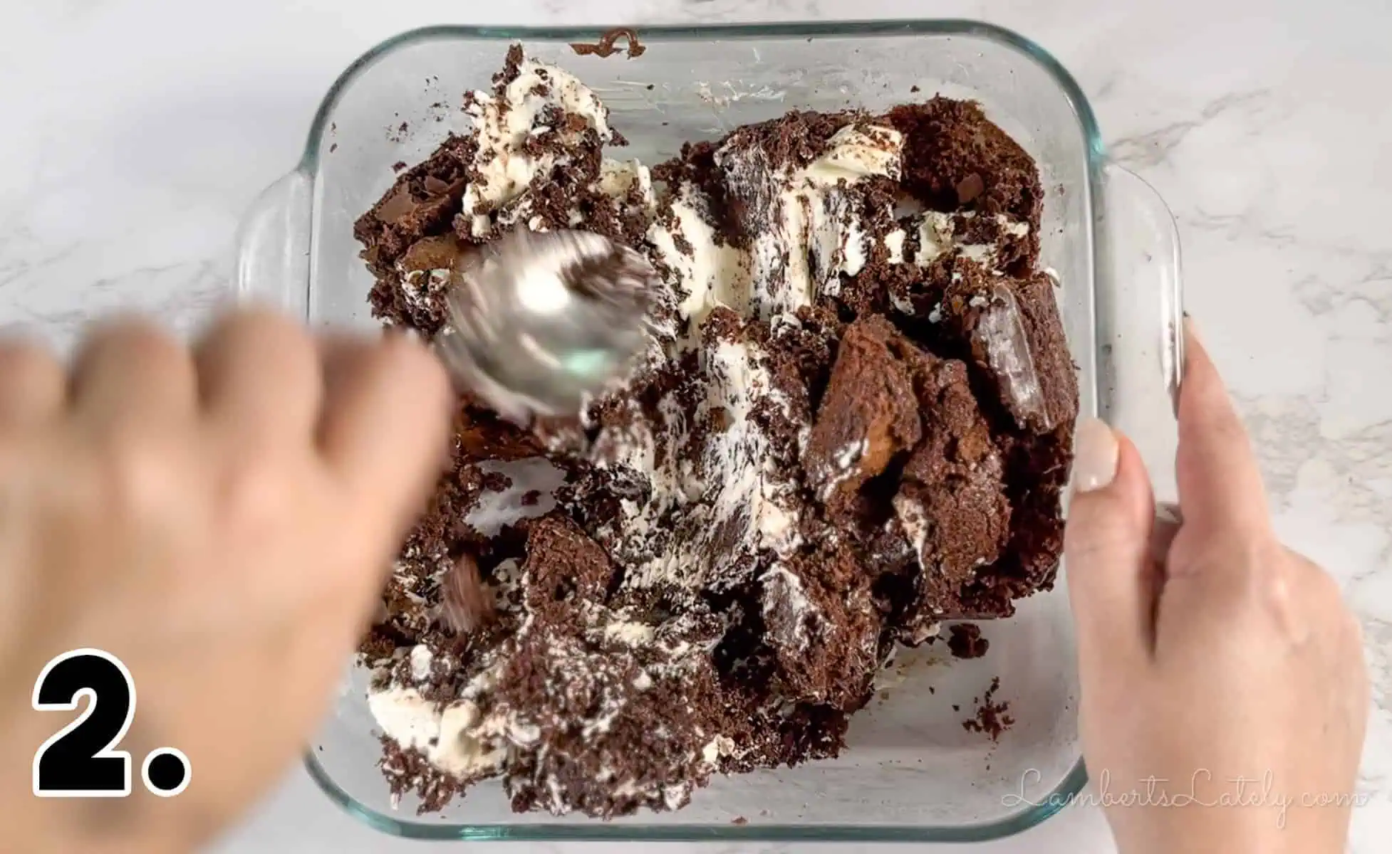 mixing cream cheese into crumbled brownies.