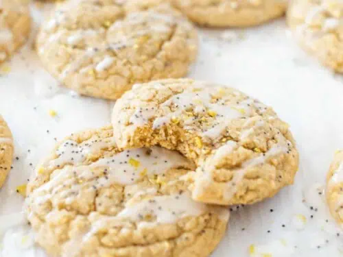 lemon poppy seed cookies scattered around, one missing a bite.