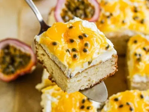holding a slice of passion fruit cake on a serving fork.