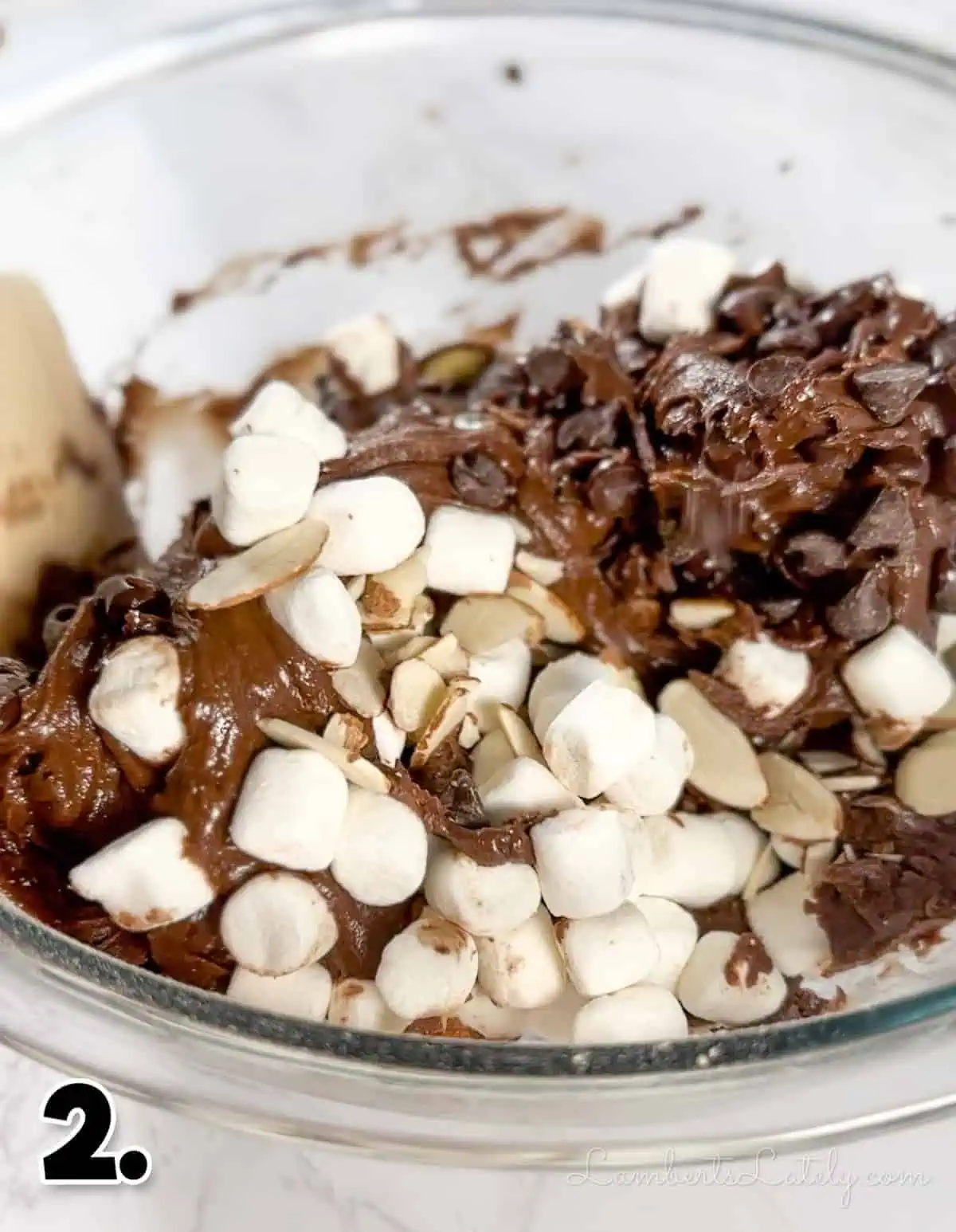 folding in marshmallows, chocolate chips, and  almonds into brownie mix.