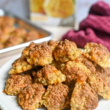 sausage balls on a plate in front of a box of red lobster chedday bay biscuit mix.