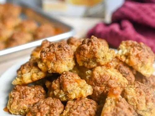 sausage balls on a plate in front of a box of red lobster chedday bay biscuit mix.