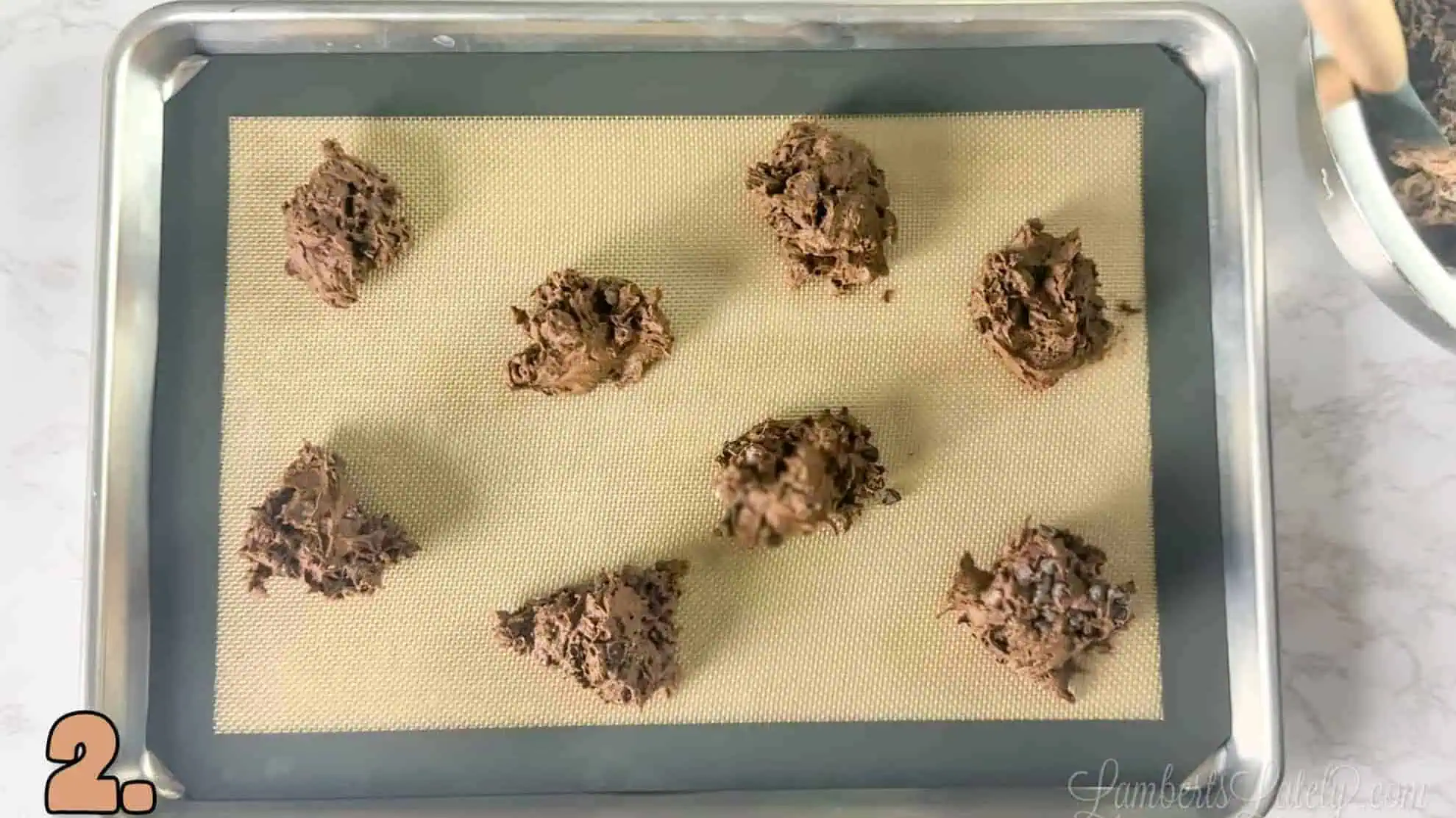 brownie mix cookie dough scooped onto a baking sheet in small portions.