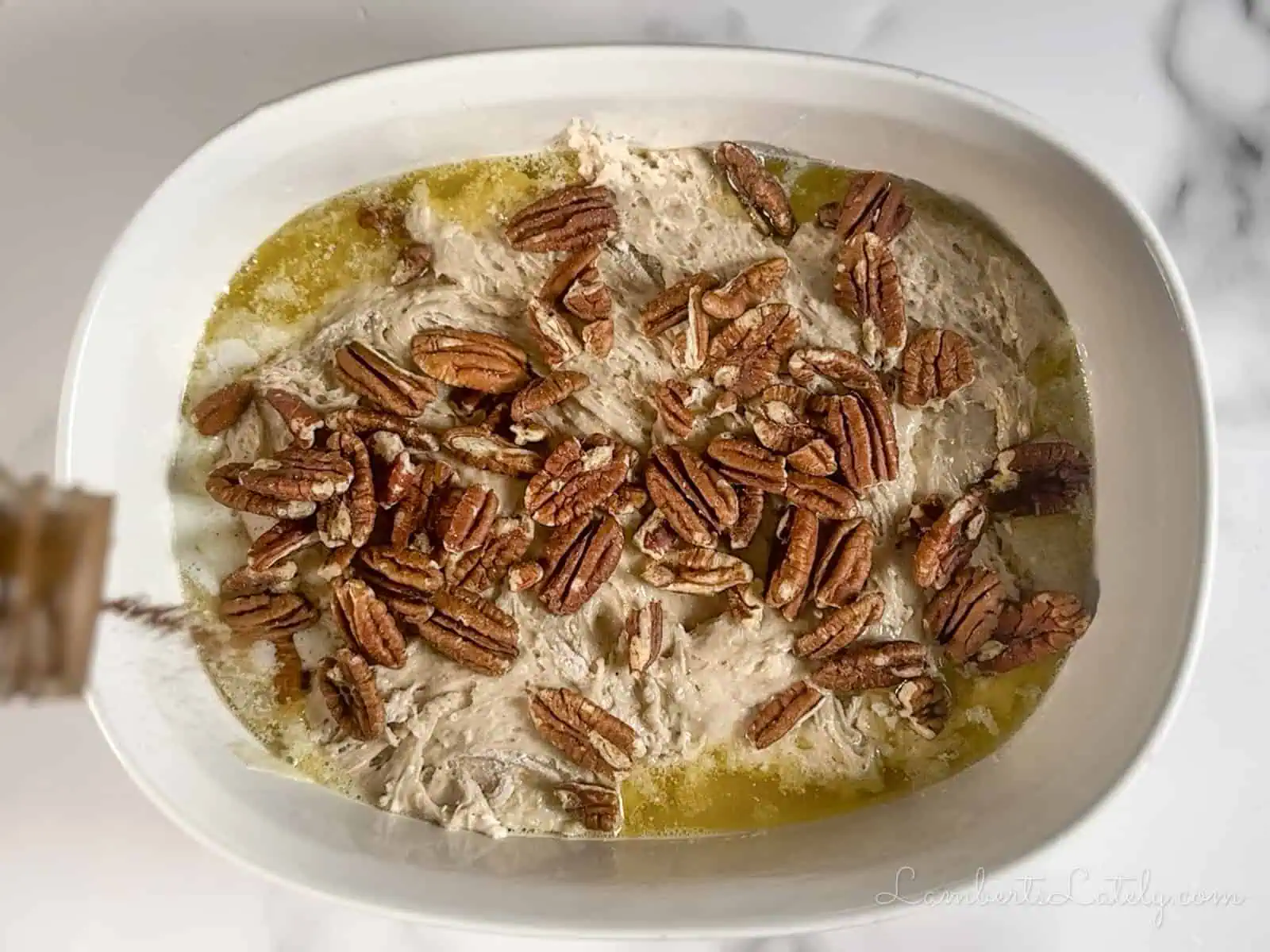 sprinkling cinnamon and pecans over cake mix and butter.