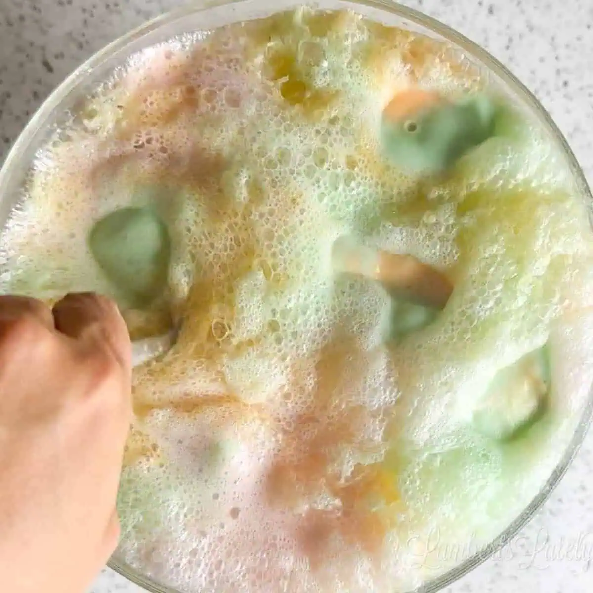 Stirring a punch bowl of  Rainbow Sherbet punch.