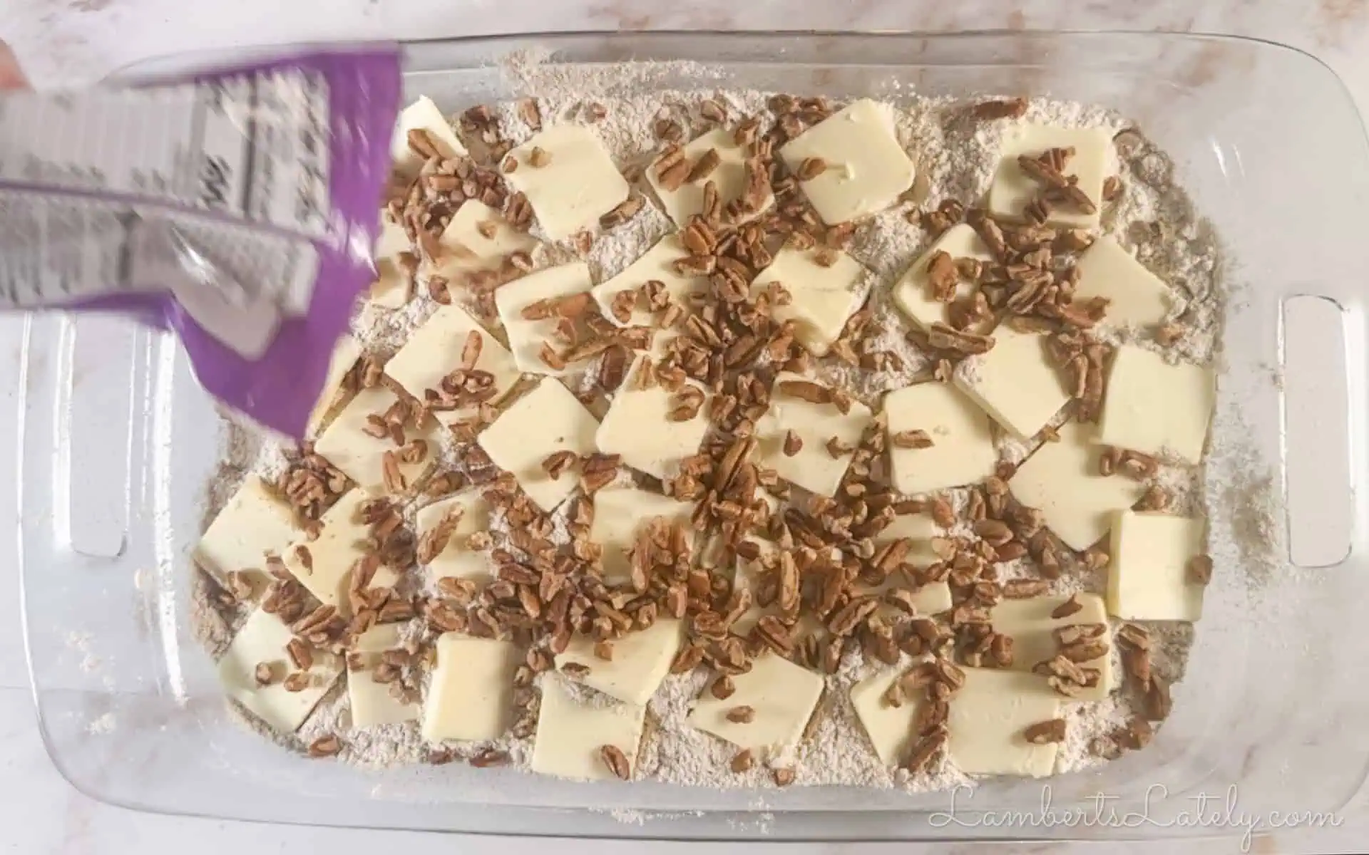 pouring pecans over butter slices.