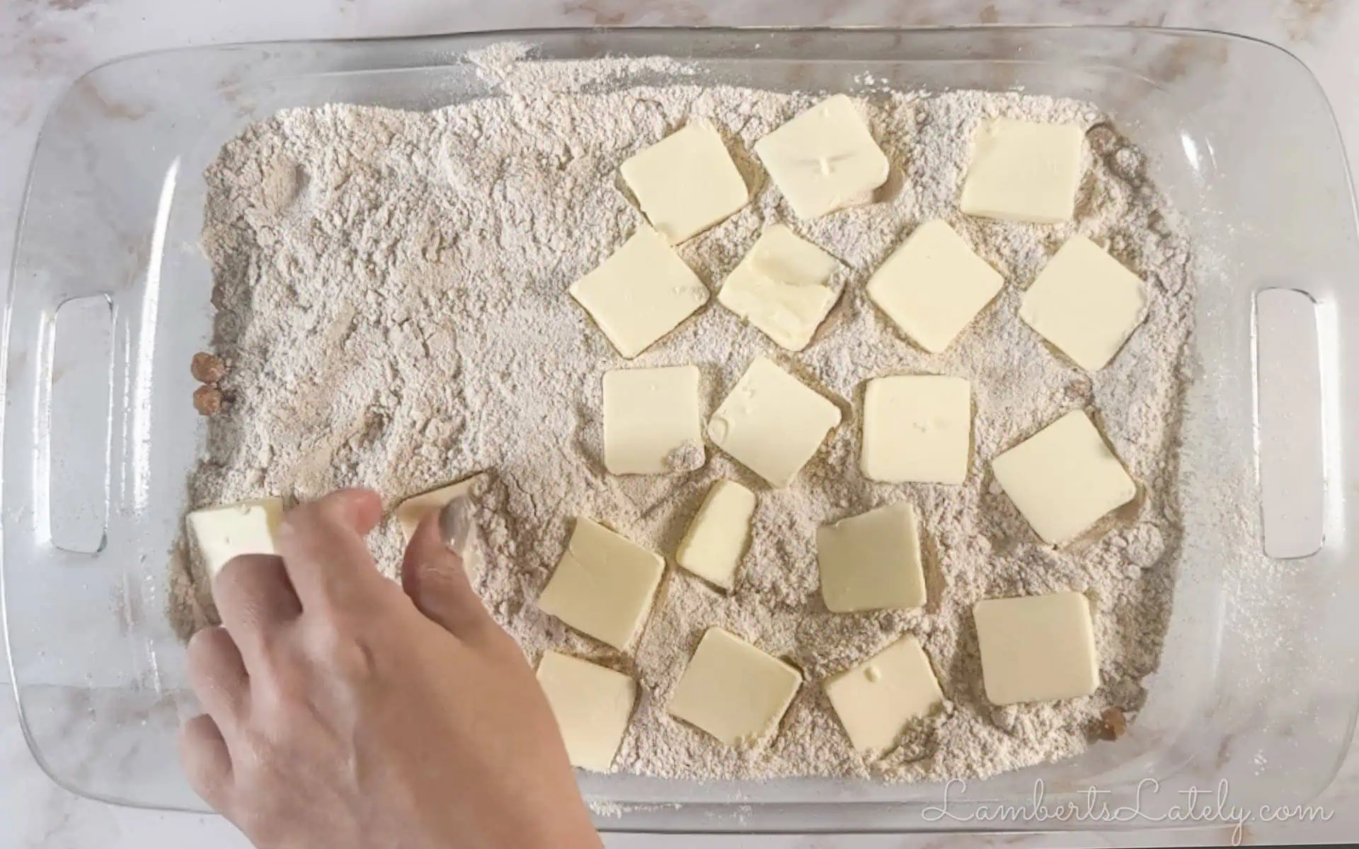 putting butter slices over cake mix.