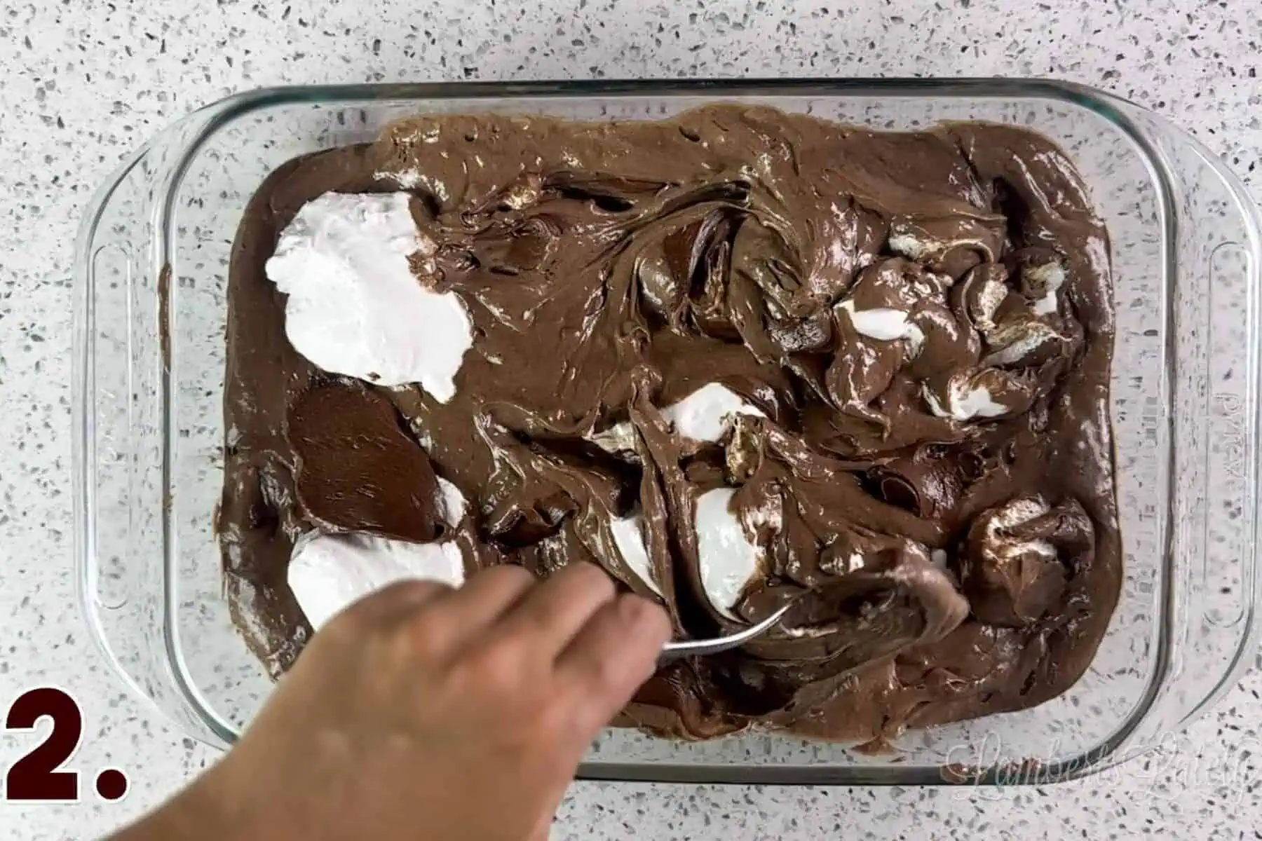 swirling marshmallow fluff and chocolate frosting into a cake batter.