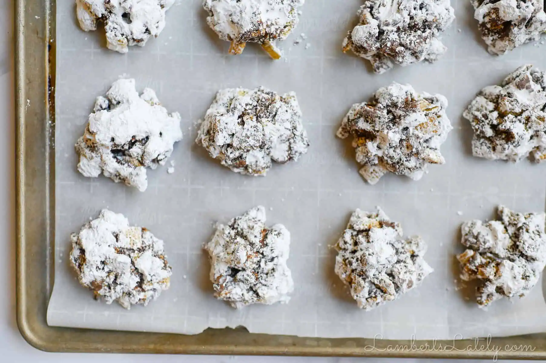 muddy buddy cookies on a sheet pan.