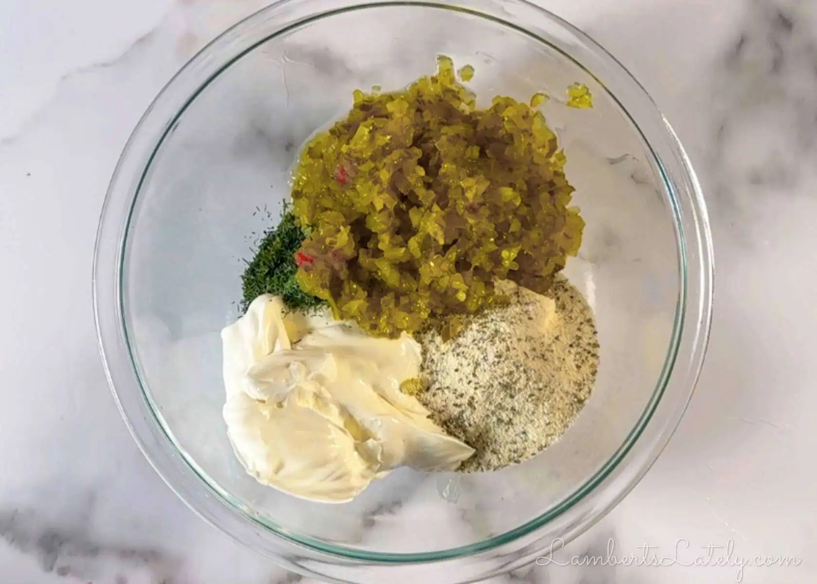 ingredients for fried dill pickle dip in a bowl.