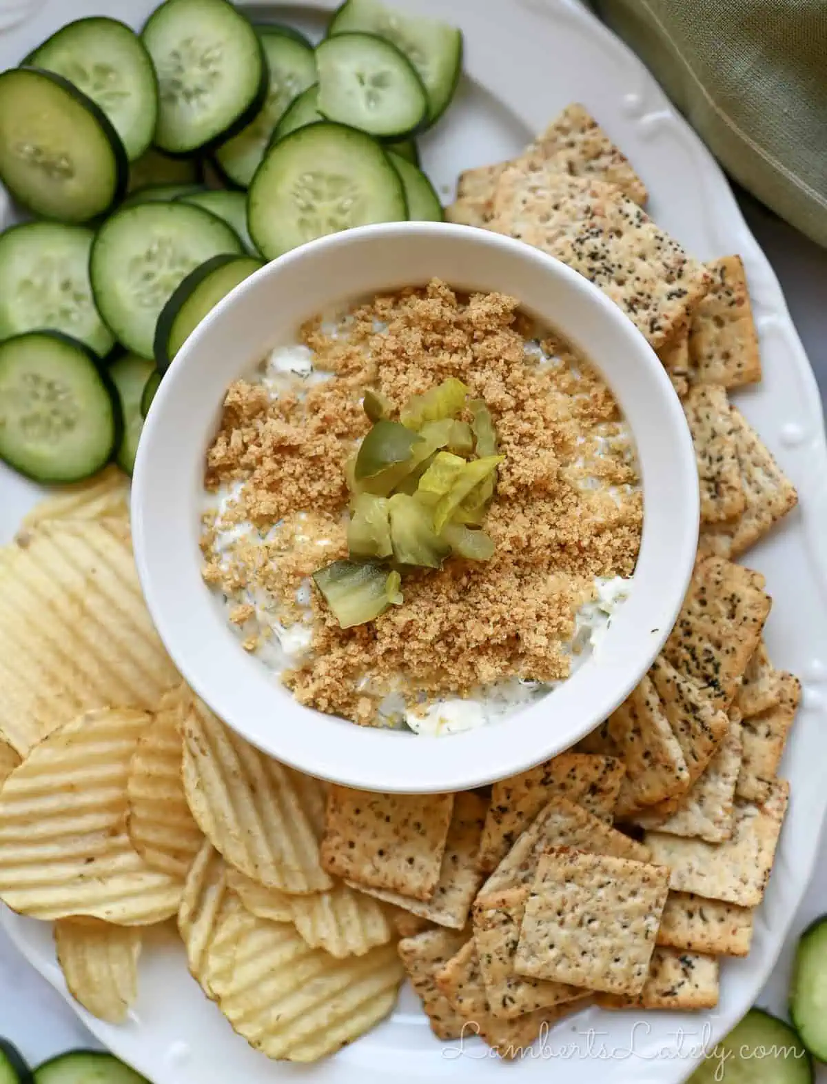 fried pickle dip surrounded by dippers on a platter.