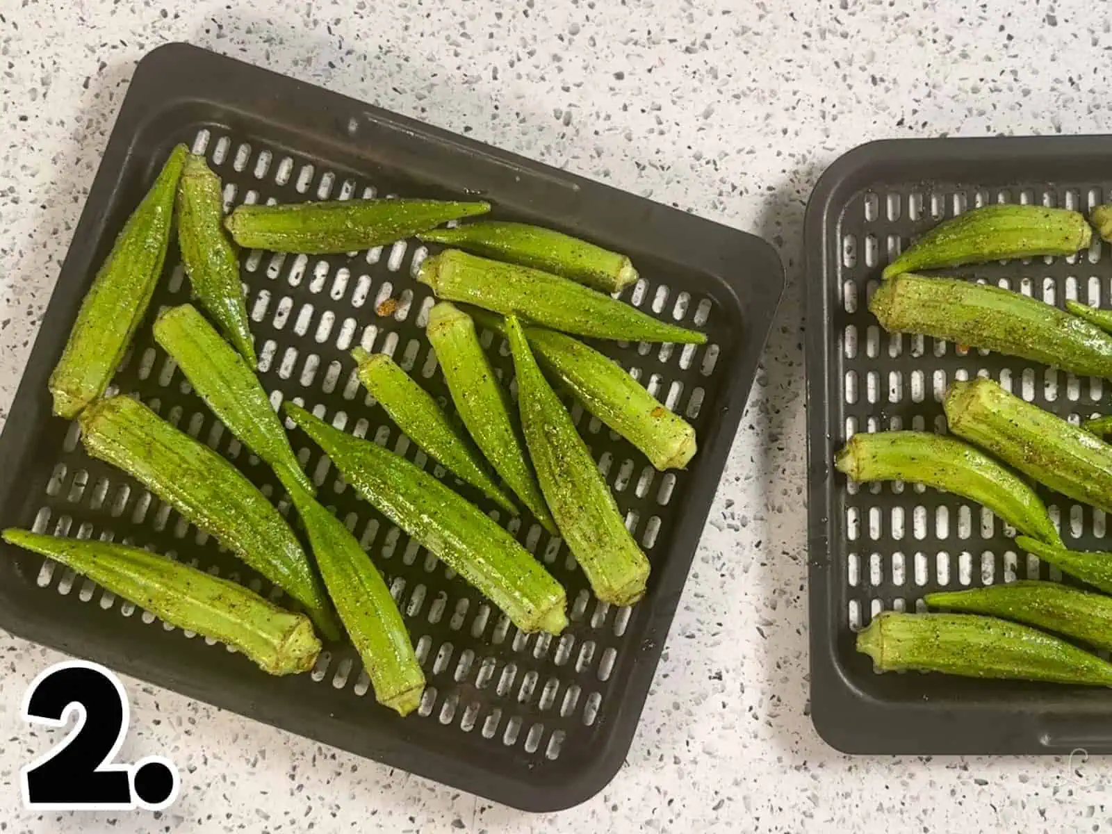 seasoned okra on air fryer trays.