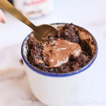 digging a spoon into a nutella mug cake.