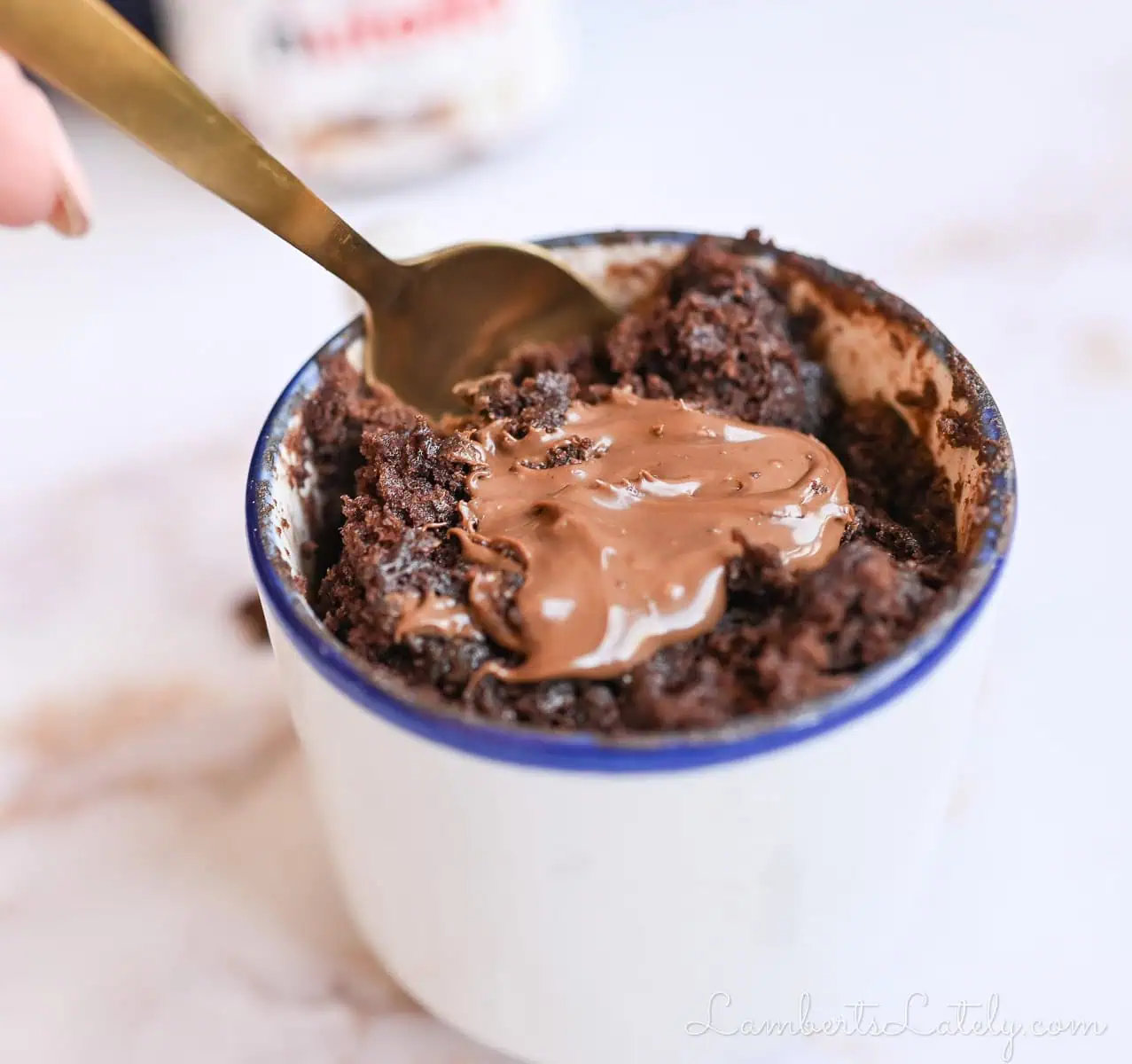 digging a spoon into a nutella mug cake.