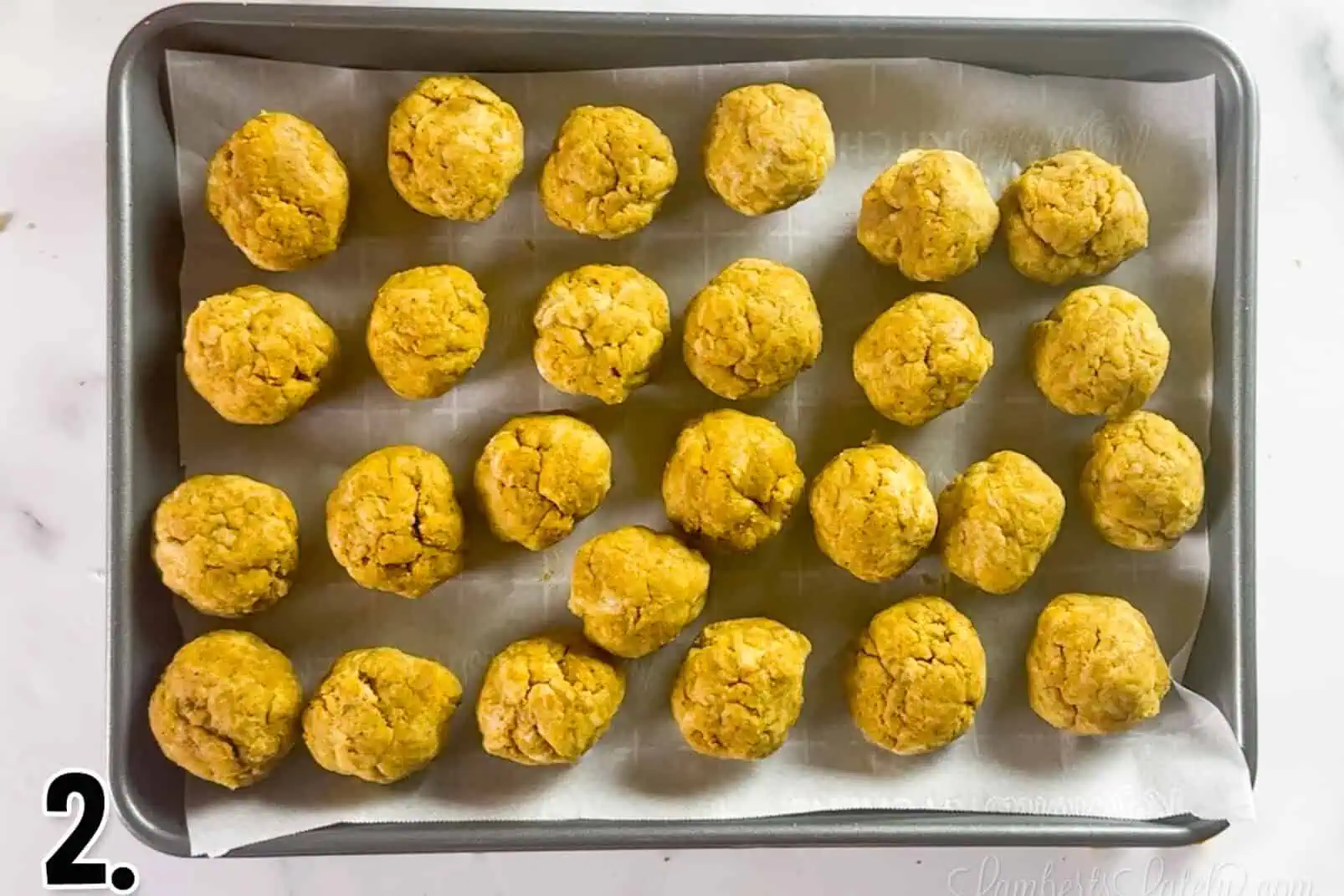 cake balls on a metal pan.