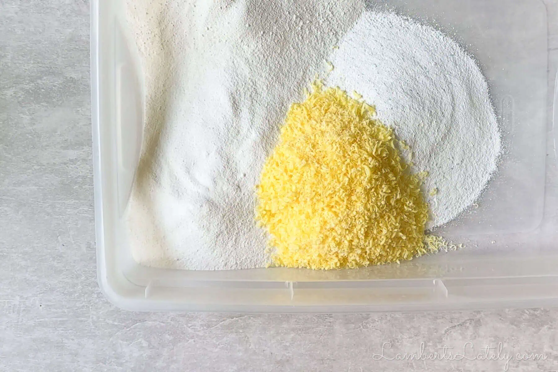 ingredients for diy laundry powder in a large container, before stirring.